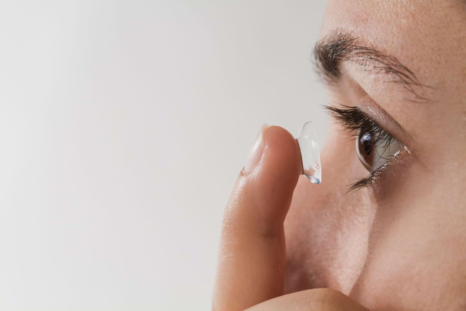 Femme mettant des lentilles de contact dans l'œil